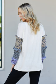 Heimish Full Size Animal Print Ruffle Trim Top
