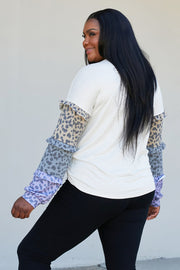 Heimish Full Size Animal Print Ruffle Trim Top