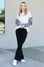 Heimish Full Size Animal Print Ruffle Trim Top